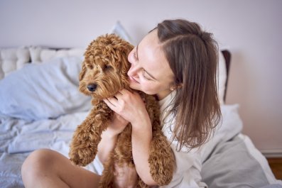 Woman Reveals Letting Crate Trained Dog Sleep in Her Bed Was 'Best Thing'